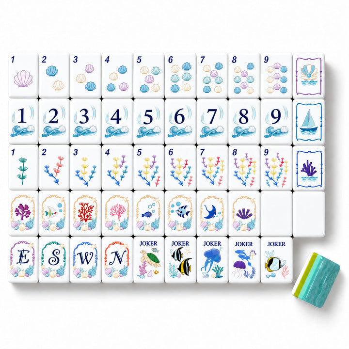 Large size Coastal Ocean American Mahjong tile set from the Artistry Collection by The Mahjong Tile, featuring seashell dots, sailboat bams, coral craks, marine life jokers, and blue-green acrylic backs.