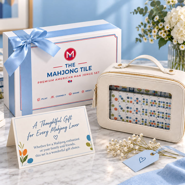 Luxury gift packaging presentation for the Geometric American Mahjong set from the Artistry Collection by The Mahjong Tile, featuring a tied-ribbon retail box, cream carrying case, and gift card.