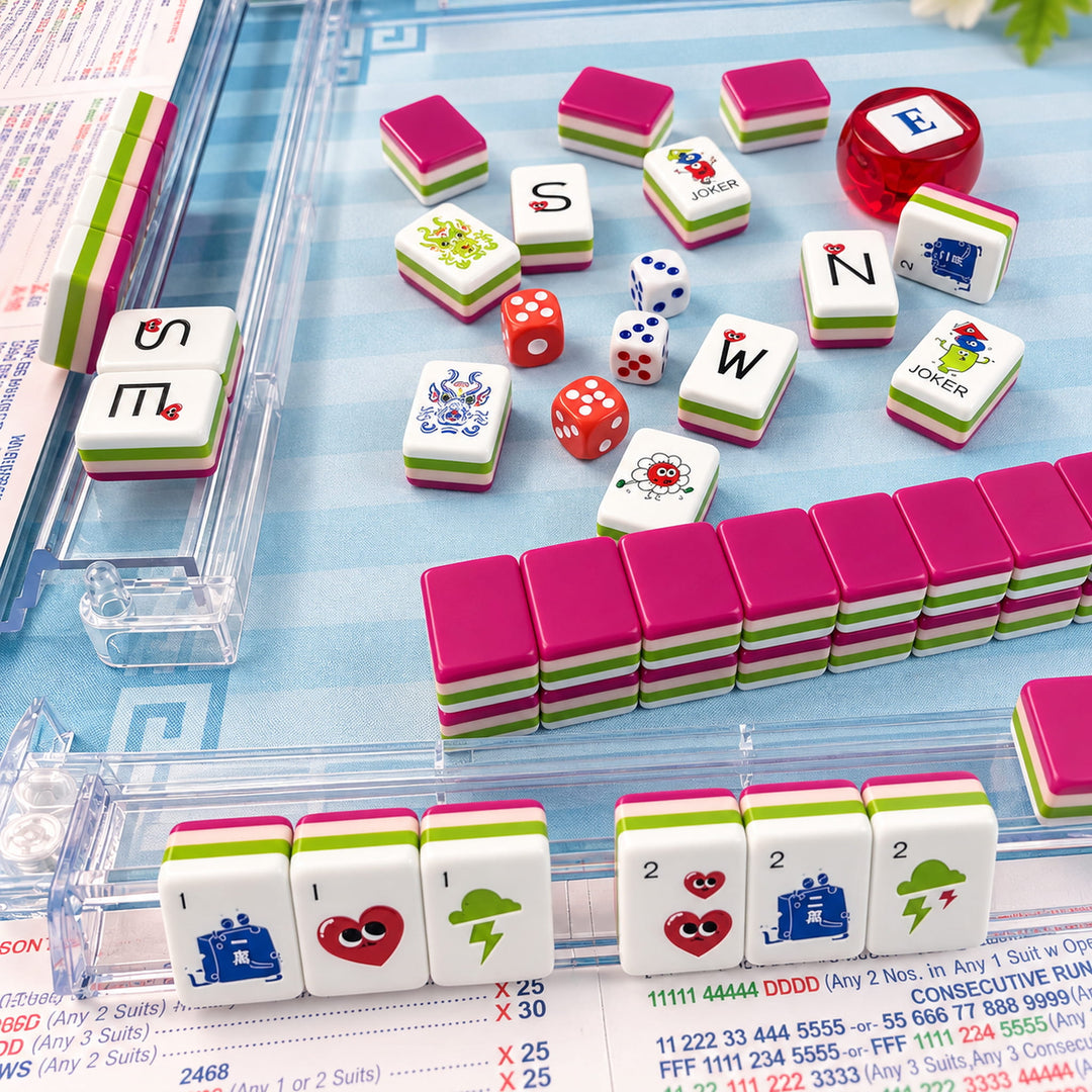 Real game night lifestyle setup for the Heart American Mahjong tile set from the Artistry Collection by The Mahjong Tile, featuring clear acrylic racks and dice on a blue game mat.