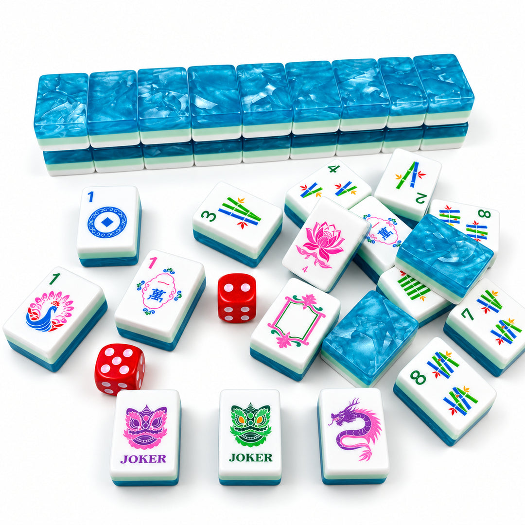 An alternate close-up view of Ocean Blue acrylic American Mahjong tiles from The Mahjong Tile, showing both the Classic Bloom traditional illustrations (with Jokers and flowers) and the multi-layer shimmering wave back design with red dice.